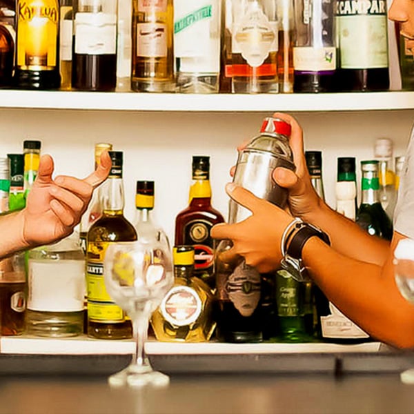 man's hand using a shaker at bartending school