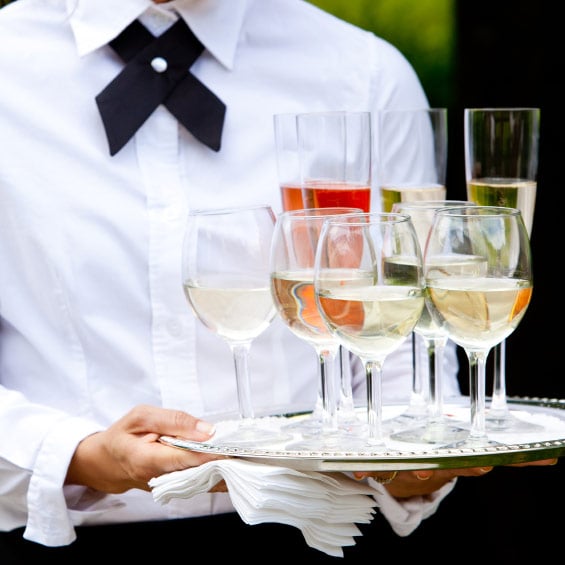 Catering server with tray of glasses