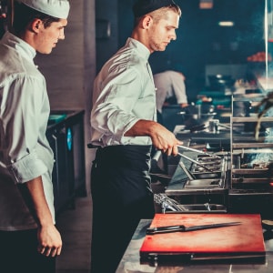 Line Cook learning from Sous Chef