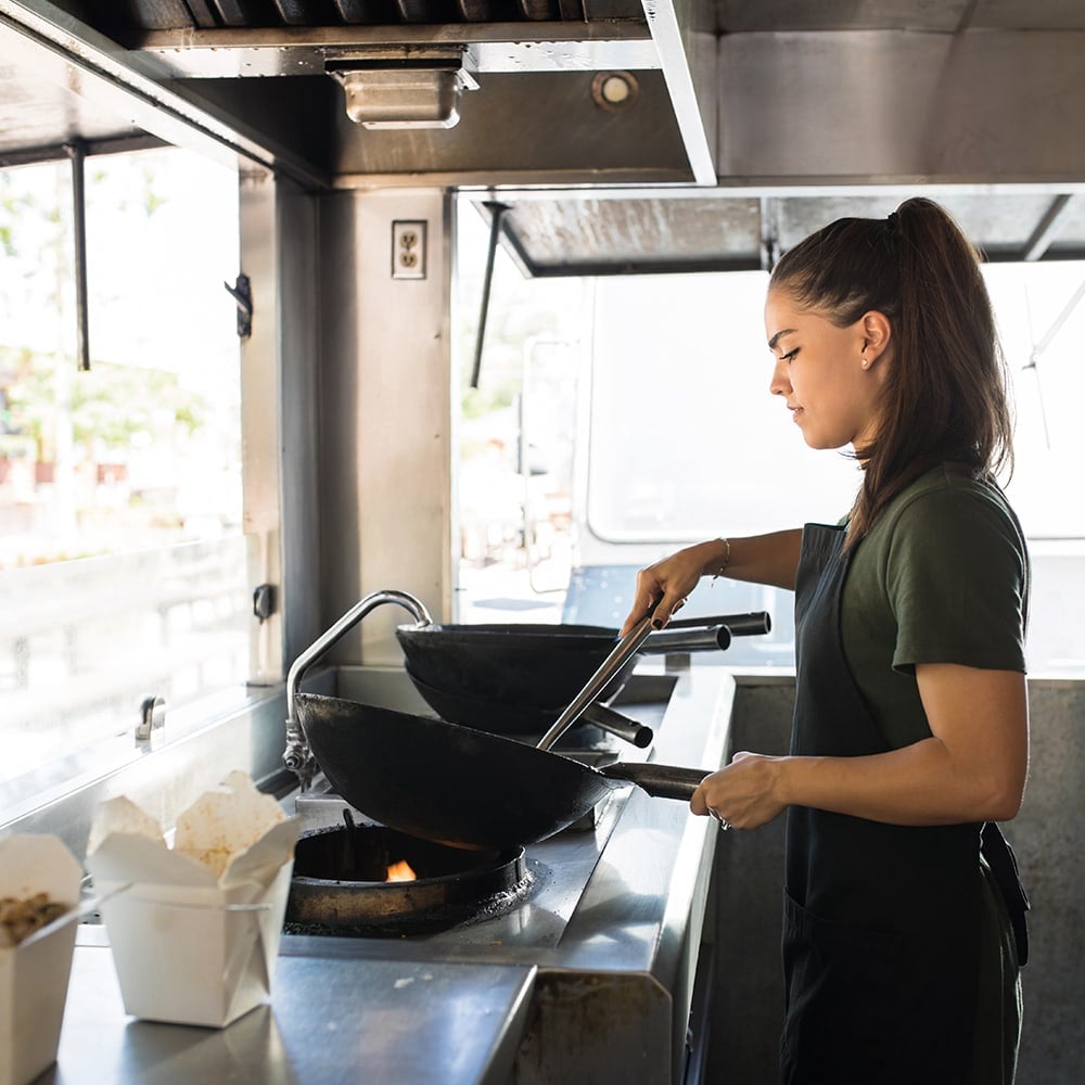 woman cooking in a food truck