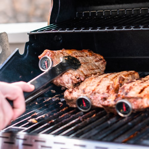 Meat Thermometer in steaks on a grill